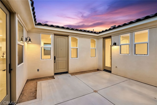 7408 Desert Sky Dr, Yucca Valley, CA 92284 - doorway to property featuring a patio area, stucco siding, and a tiled roof