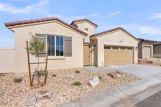 7408 Desert Sky Dr, Yucca Valley, CA 92284 - mediterranean / spanish house featuring a garage, stucco siding, concrete driveway, and a tiled roof
