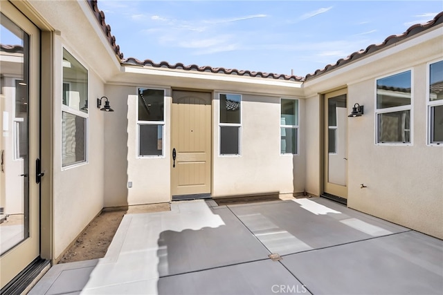 7408 Desert Sky Dr, Yucca Valley, CA 92284 - entrance to property featuring stucco siding, a tiled roof, and a patio