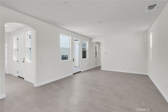 7408 Desert Sky Dr, Yucca Valley, CA 92284 - spare room featuring arched walkways and baseboards
