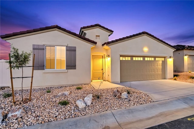 7408 Desert Sky Dr, Yucca Valley, CA 92284 - mediterranean / spanish-style home with a garage, driveway, stucco siding, and a tiled roof