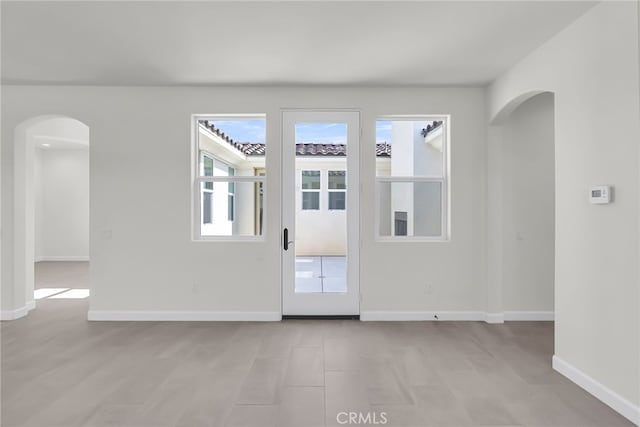 7408 Desert Sky Dr, Yucca Valley, CA 92284 - empty room with arched walkways and baseboards