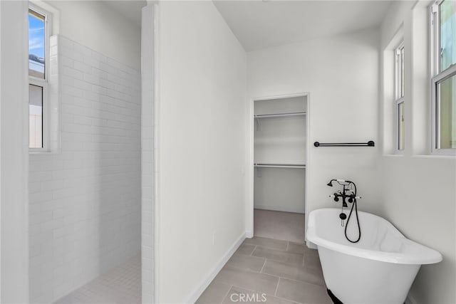 7408 Desert Sky Dr, Yucca Valley, CA 92284 - bathroom featuring a soaking tub, a tile shower, and a spacious closet