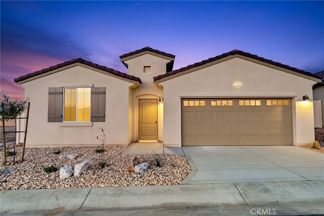 7408 Desert Sky Dr, Yucca Valley, CA 92284 - mediterranean / spanish home with a garage, stucco siding, a tile roof, and driveway