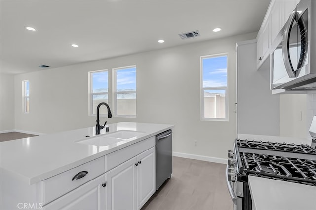 7408 Desert Sky Dr, Yucca Valley, CA 92284 - kitchen featuring stainless steel appliances, healthy amount of natural light, white cabinets, light countertops, and recessed lighting
