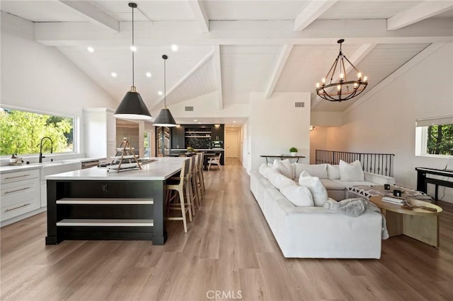 3532 Mesquite Dr, Calabasas, CA 91302 - living room with high vaulted ceiling, beamed ceiling, light wood-style flooring, and a chandelier