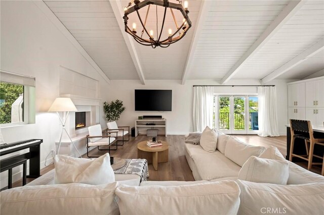 3532 Mesquite Dr, Calabasas, CA 91302 - living room with a chandelier, wood finished floors, and a warm lit fireplace
