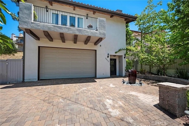 3532 Mesquite Dr, Calabasas, CA 91302 - mediterranean / spanish home featuring a balcony, a garage, stucco siding, and decorative driveway