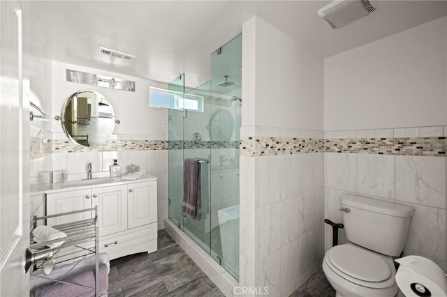 3532 Mesquite Dr, Calabasas, CA 91302 - full bathroom with tile walls, vanity, a stall shower, and wainscoting