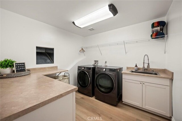 3532 Mesquite Dr, Calabasas, CA 91302 - laundry room with independent washer and dryer, light wood finished floors, and cabinet space