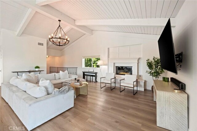 3532 Mesquite Dr, Calabasas, CA 91302 - living area with a chandelier, light wood finished floors, a wooden ceiling with exposed beams, high vaulted ceiling, and a glass covered fireplace