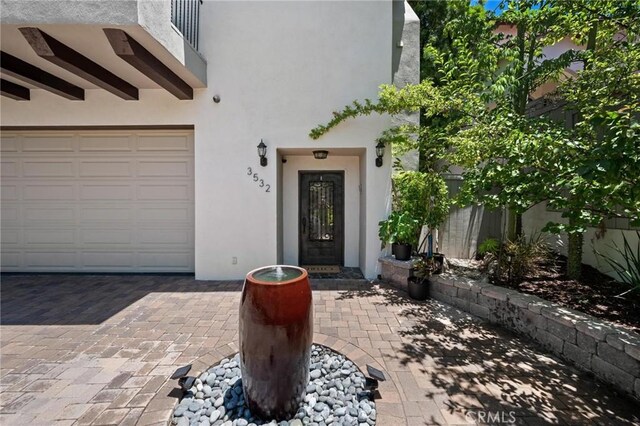 3532 Mesquite Dr, Calabasas, CA 91302 - view of exterior entry with stucco siding and a garage