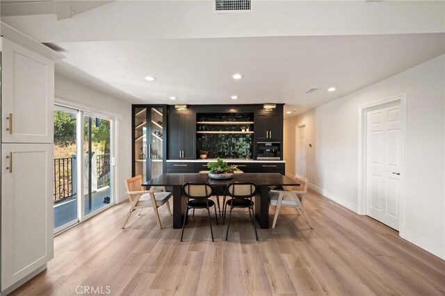 3532 Mesquite Dr, Calabasas, CA 91302 - bar featuring light wood-type flooring, recessed lighting, and black oven