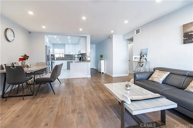 1236 N Columbus Ave Unit 28, Glendale, CA 91202 - living area with light wood finished floors and recessed lighting