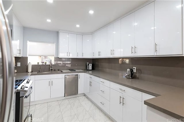 1236 N Columbus Ave Unit 28, Glendale, CA 91202 - kitchen featuring stainless steel dishwasher, gas range, white cabinets, tasteful backsplash, and modern cabinets