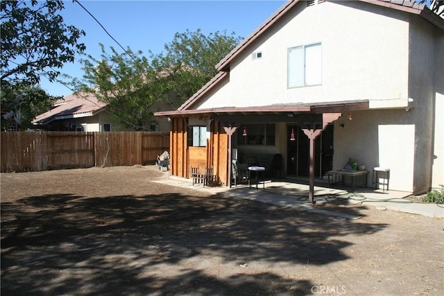 44535 Aspen St, Lancaster, CA 93535 - back of house with stucco siding and a patio area