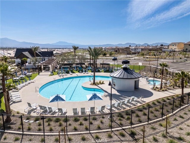 554 Cumberland Rd, Rialto, CA 92377 - community pool featuring a mountain view, a patio area, and a residential view