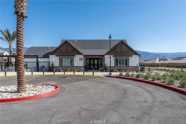 554 Cumberland Rd, Rialto, CA 92377 - view of building exterior with a mountain view and uncovered parking