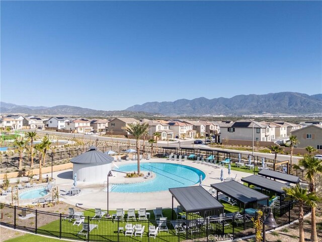 554 Cumberland Rd, Rialto, CA 92377 - community pool with a mountain view, a residential view, and a patio
