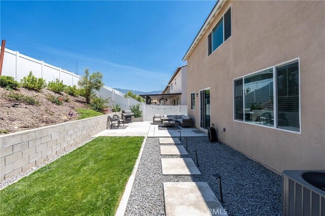 554 Cumberland Rd, Rialto, CA 92377 - fenced backyard with an outdoor living space and a patio area
