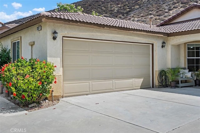 23317 Badger Creek Ln, Menifee, CA 92587 - garage featuring driveway and a mountain view