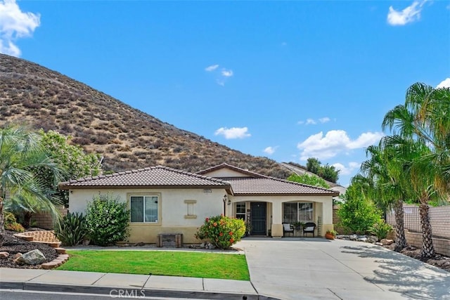 23317 Badger Creek Ln, Menifee, CA 92587 - back of house with a mountain view, stucco siding, driveway, and a tile roof