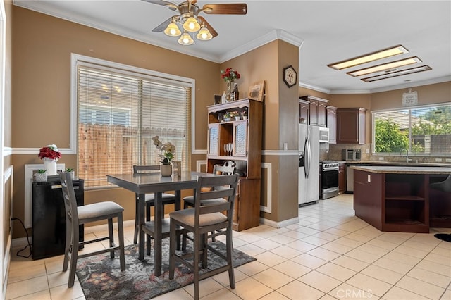 2802 Silver Shore Ln, Bakersfield, CA 93313 - dining room with light tile patterned flooring, crown molding, and a ceiling fan