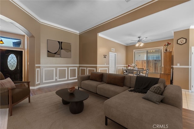 2802 Silver Shore Ln, Bakersfield, CA 93313 - living room featuring ornamental molding, arched walkways, wood finished floors, a ceiling fan, and wainscoting