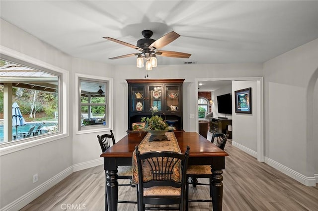 1624 Alessandro Rd, Redlands, CA 92373 - dining area with light wood-style flooring, a ceiling fan, and arched walkways