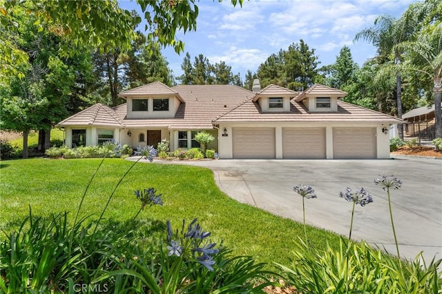 1624 Alessandro Rd, Redlands, CA 92373 - view of front of property with concrete driveway, a garage, a front lawn, stucco siding, and a chimney