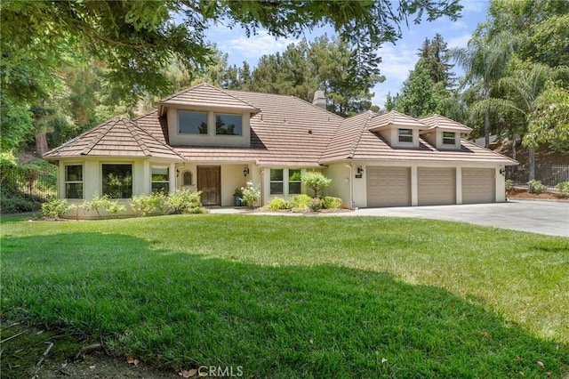 1624 Alessandro Rd, Redlands, CA 92373 - view of front of home with stucco siding, an attached garage, driveway, and a front lawn