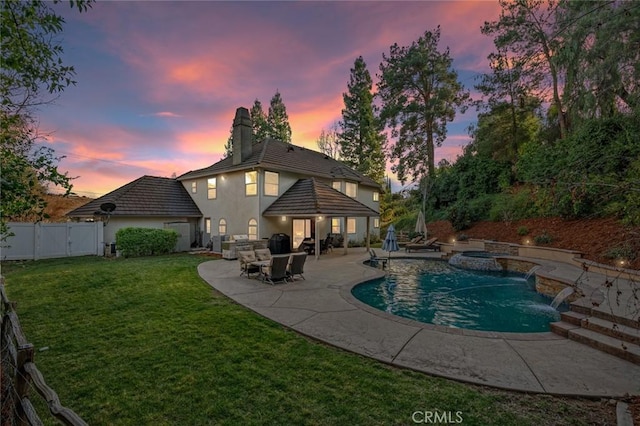1624 Alessandro Rd, Redlands, CA 92373 - back of property with a fenced backyard, stucco siding, a chimney, a patio area, and a pool with connected hot tub