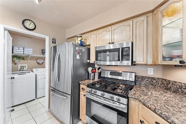 861 Shade Tree Way, Corona, CA 92878 - kitchen with stainless steel appliances, light brown cabinets, independent washer and dryer, and dark stone counters