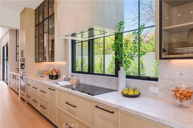 16711 Moorpark St, Encino, CA 91436 - bar area featuring black electric stovetop, decorative backsplash, oven, and light wood-style floors