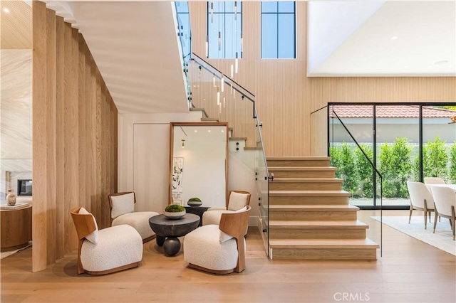 16711 Moorpark St, Encino, CA 91436 - stairs with wooden walls, wood finished floors, and a towering ceiling