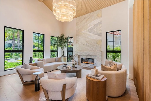 16711 Moorpark St, Encino, CA 91436 - living room featuring a chandelier, healthy amount of natural light, a premium fireplace, a high ceiling, and wooden ceiling
