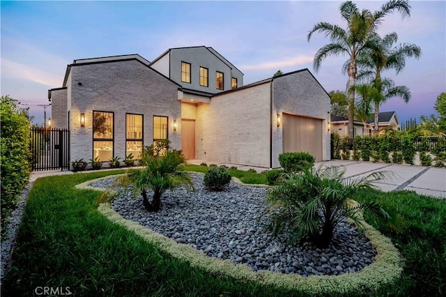 16711 Moorpark St, Encino, CA 91436 - view of front of property with driveway, a garage, stucco siding, and brick siding