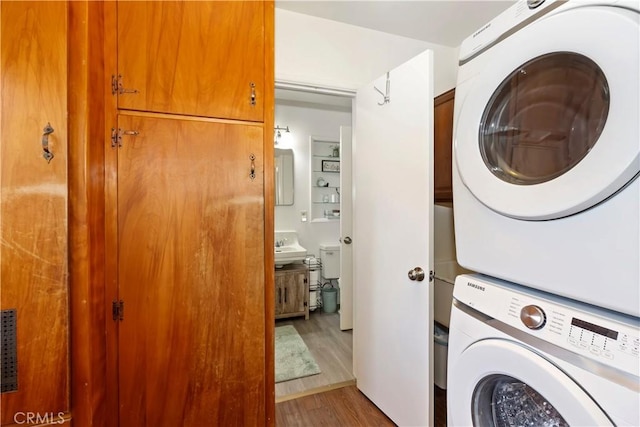 8356 Duarte Rd, San Gabriel, CA 91775 - laundry area featuring stacked washing machine and dryer and wood finished floors