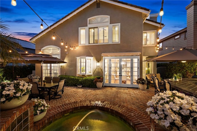42 Fairlane Rd, Laguna Niguel, CA 92677 - back of property featuring french doors, stucco siding, a patio, and outdoor dining space
