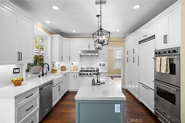 42 Fairlane Rd, Laguna Niguel, CA 92677 - kitchen featuring appliances with stainless steel finishes, a chandelier, under cabinet range hood, a center island, and white cabinetry
