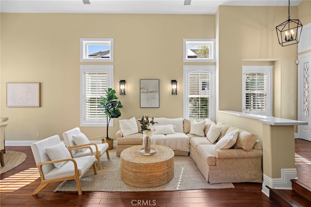 42 Fairlane Rd, Laguna Niguel, CA 92677 - living room with dark wood finished floors, a towering ceiling, and a chandelier