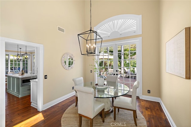 42 Fairlane Rd, Laguna Niguel, CA 92677 - dining room featuring a high ceiling, a chandelier, dark wood finished floors, and french doors