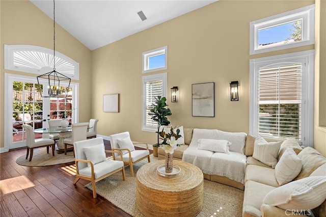 42 Fairlane Rd, Laguna Niguel, CA 92677 - living room with high vaulted ceiling, a chandelier, healthy amount of natural light, and dark wood-type flooring