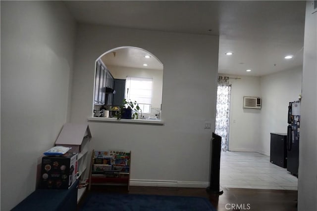 18347 Saticoy St Unit 33, Reseda, CA 91335 - hallway with a wall mounted AC, recessed lighting, healthy amount of natural light, arched walkways, and tile patterned flooring