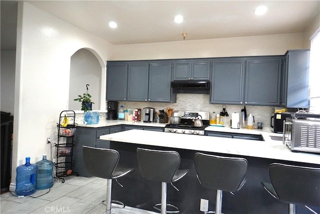 18347 Saticoy St Unit 33, Reseda, CA 91335 - kitchen featuring stove, light countertops, decorative backsplash, and recessed lighting