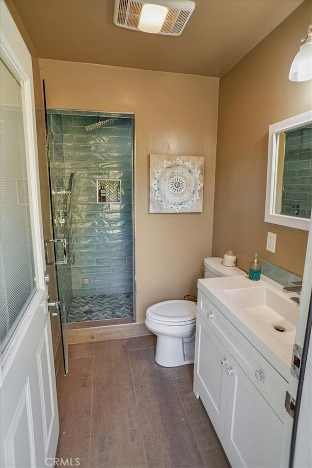 10624 Nevada Ave, Chatsworth, CA 91311 - full bath featuring vanity, a shower stall, and wood finished floors