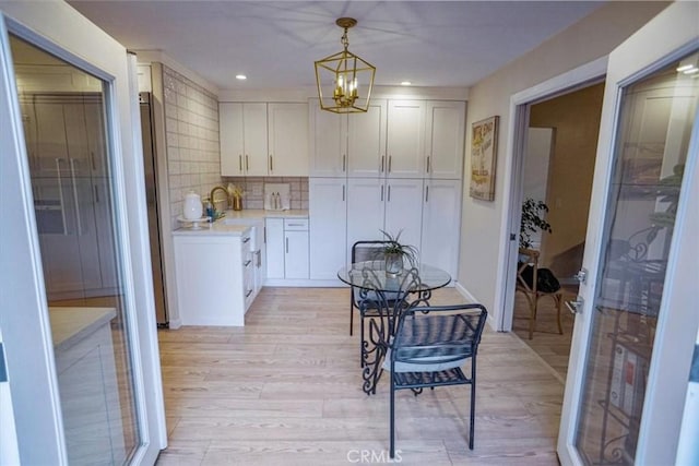 10624 Nevada Ave, Chatsworth, CA 91311 - dining area featuring light wood finished floors, a chandelier, and recessed lighting