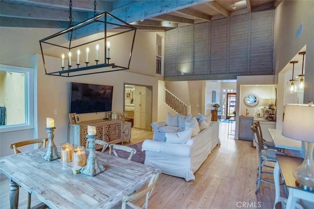 10624 Nevada Ave, Chatsworth, CA 91311 - living area with high vaulted ceiling, light wood-style flooring, beamed ceiling, plenty of natural light, and stairway