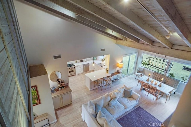 10624 Nevada Ave, Chatsworth, CA 91311 - living room with beam ceiling, light wood-type flooring, a chandelier, and a high ceiling