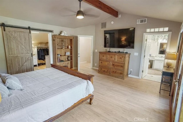 10624 Nevada Ave, Chatsworth, CA 91311 - bedroom featuring a barn door, light wood-style floors, a walk in closet, a ceiling fan, and ensuite bathroom